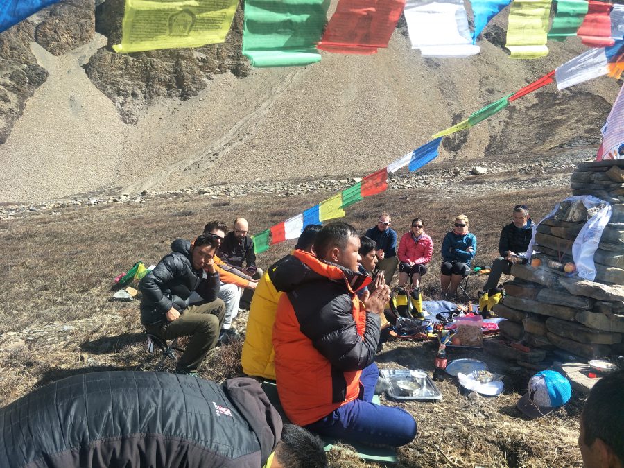 Puja by lama for climbing group before climbing.
